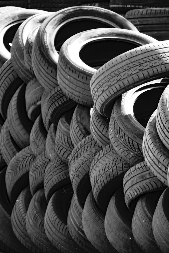 Artistic black and white image of a stack of used tires outdoors. Perfect for recycling concepts.